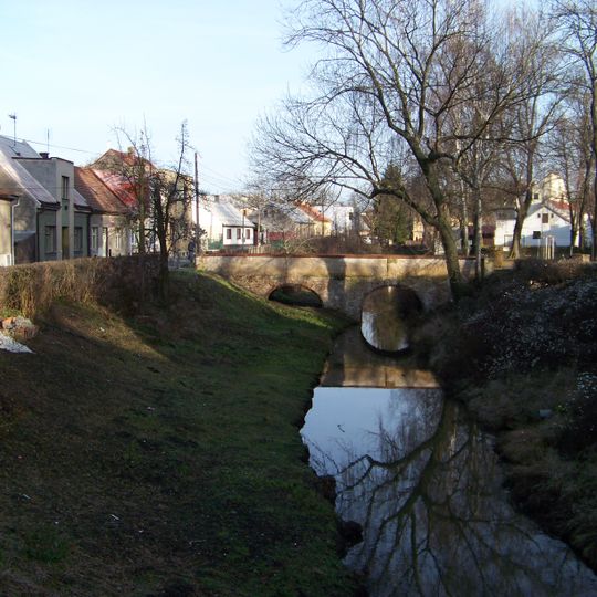 Stone arch bridge over the inner moat nearby the water tower in Nymburk