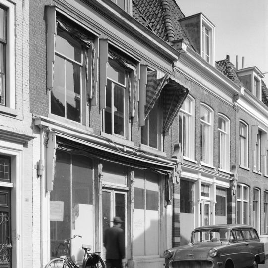 Pand met eenvoudige gevel en rechte kroonlijst gevat tussen hoekconsoles