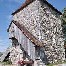 Residential tower with ensemble of small rural buildings