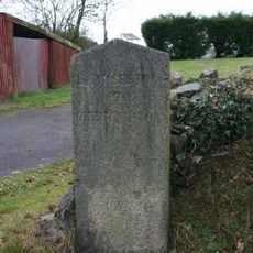 Milestone, Royal Exchange B&B car park, 50m W of minor road to Stowford