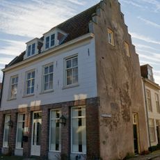 Pand met verdieping en rechts een hoge trapgevel, laat-middeleeuws