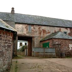 Gatehouse and barn abutting west end at Bratton Court