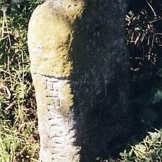 Milestone, just N of jct with School Road, N side of post box