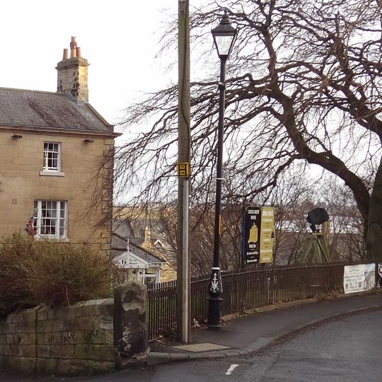 Wall And Railings Enclosing Lawn In Front Of Sun Hotel