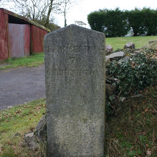 Milestone, Royal Exchange B&B car park, 50m W of minor road to Stowford