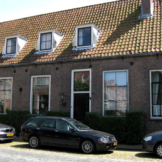 Laag langgerekt hoekpand onder zadeldak, in topgevels eindigend