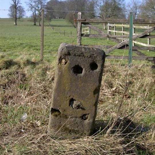 Milestone, opp. a row of houses