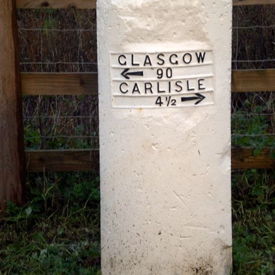 Milestone, newly constructed road for non-motorway traffic, back of Shell petrol station; M74 carriageway