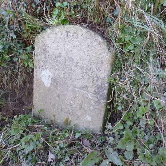 Milestone, Woolladon, half mile SE of Ash, opp wind turbine
