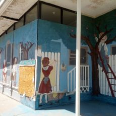 Apple orchard mural at closed gas-station