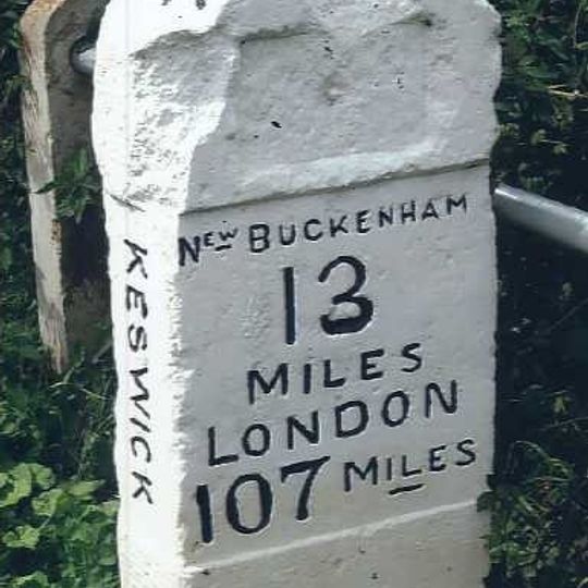 Milestone, NW side of jct with A140 next to traffic lights