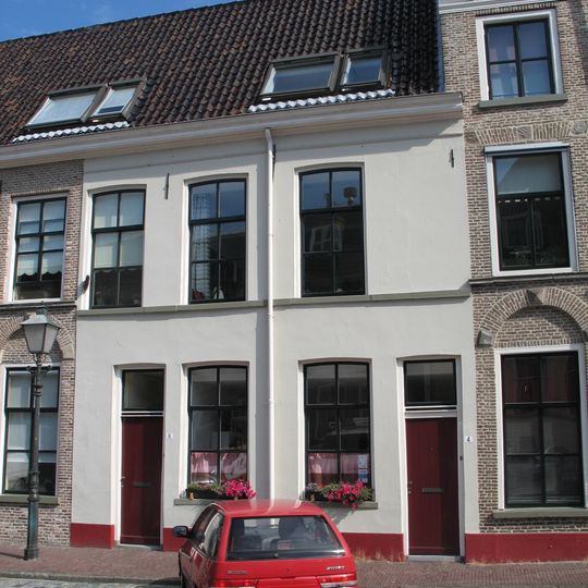 Gepleisterd pand onder dwars zadeldak samen met de nrs. 8-10 en 12