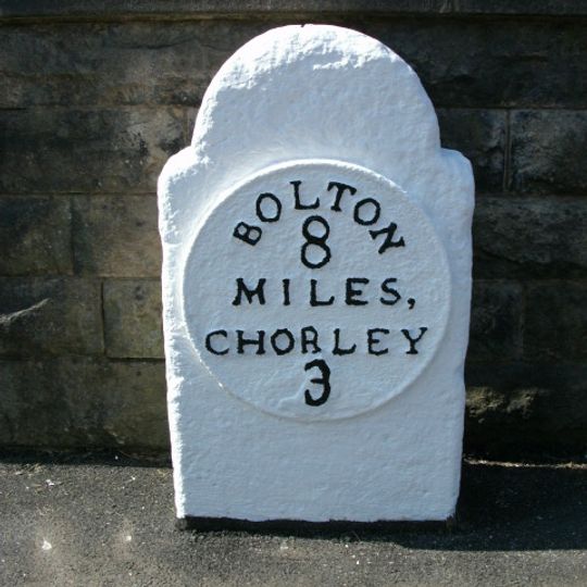 Milestone, opp.  Supermarket, by No. 18