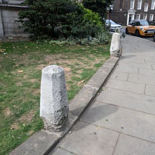13 Stone Bollards On Pavement Curb Surrounding St John's Smith Square Concert Hall