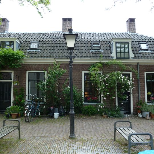 Eenlaags hoekpand onder mansardekap, op oudere kelder, vrijwoning deel uitmakend van het hofje van de Fundatie Metelerkamp