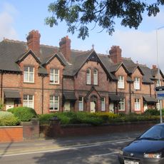Prescott's Almshouses (including associated boundary and garden walls, gateways and gate piers, and outbuildings)