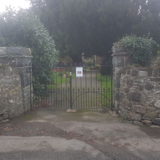 Wall, including gate piers and gate, surrounding Gyffin churchyard